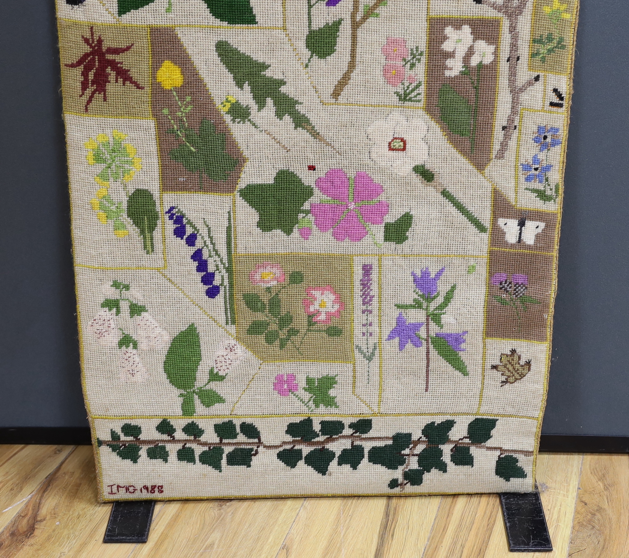 A cross-stitch wall hanging of wildflowers, 140cm high